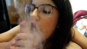 Sexy brunette with glasses licking cock while vaping